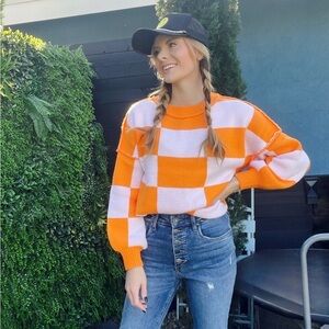 Orange and light pink checkered sweater​